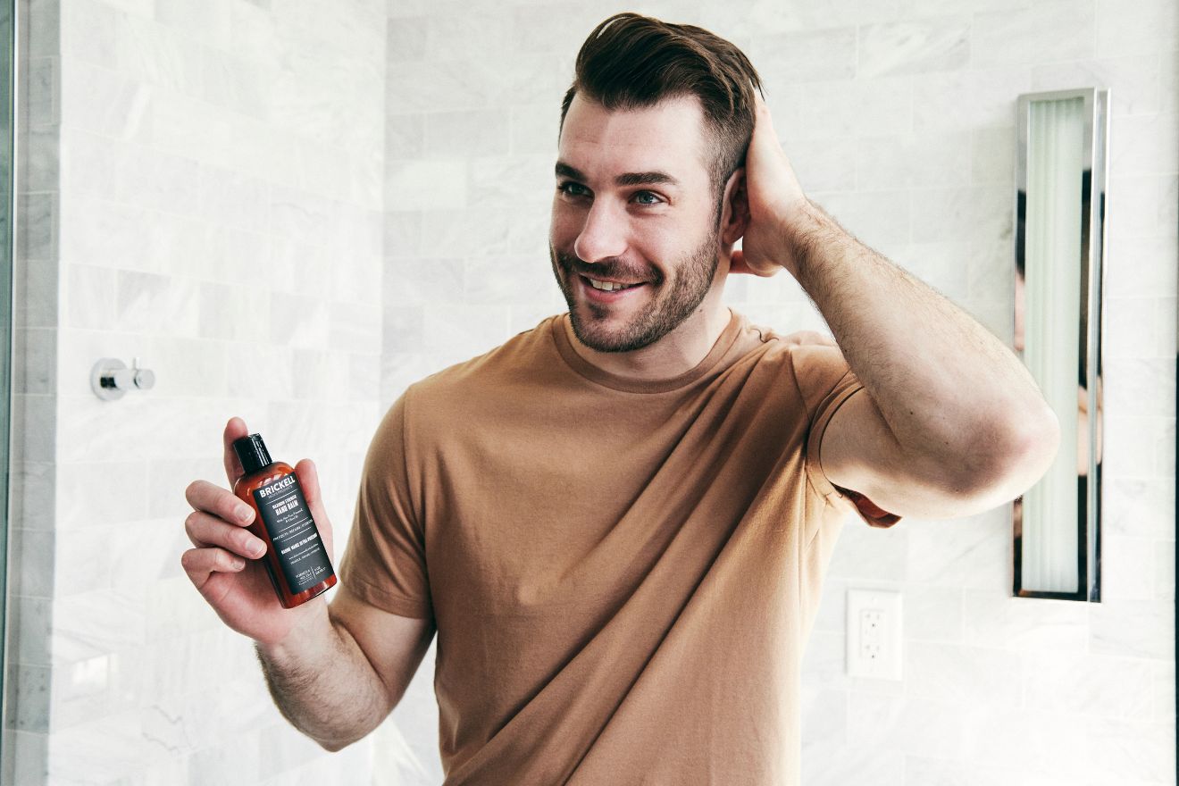 Man holding skincare product