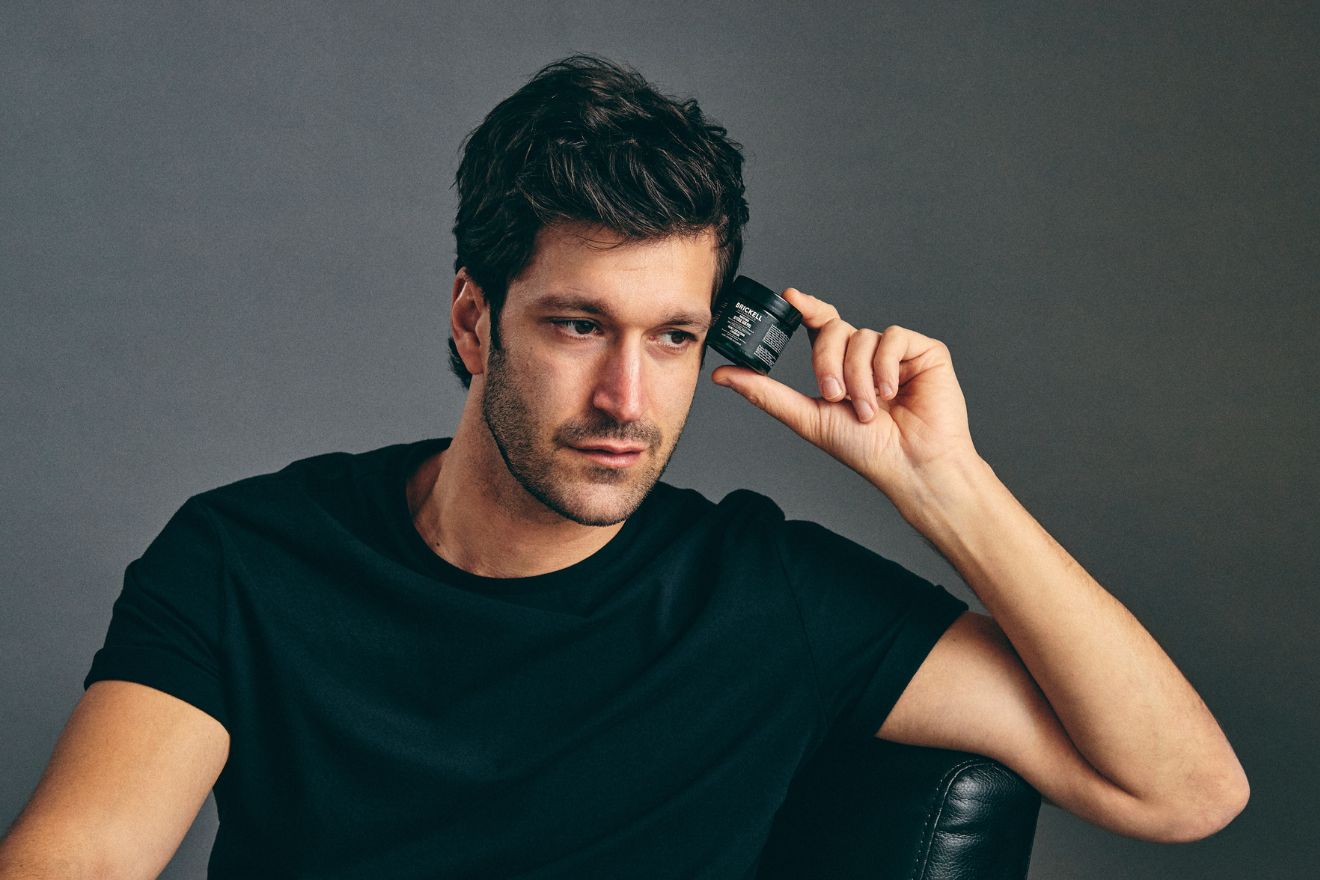 Man holding skincare product