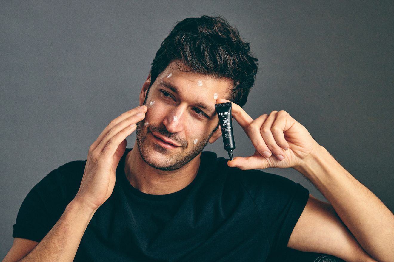 Man applying acne treatment