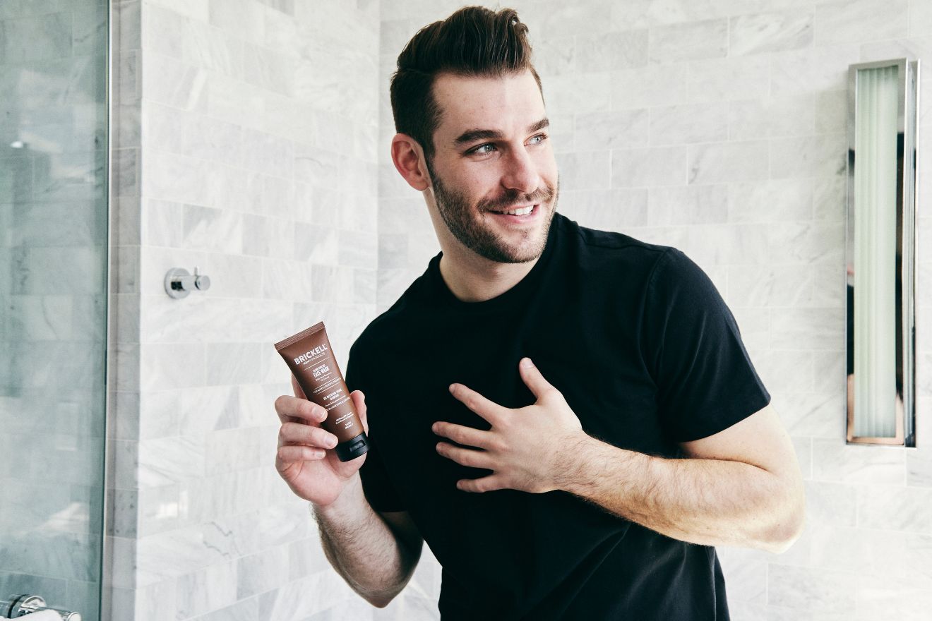 Man with beard holding skincare product