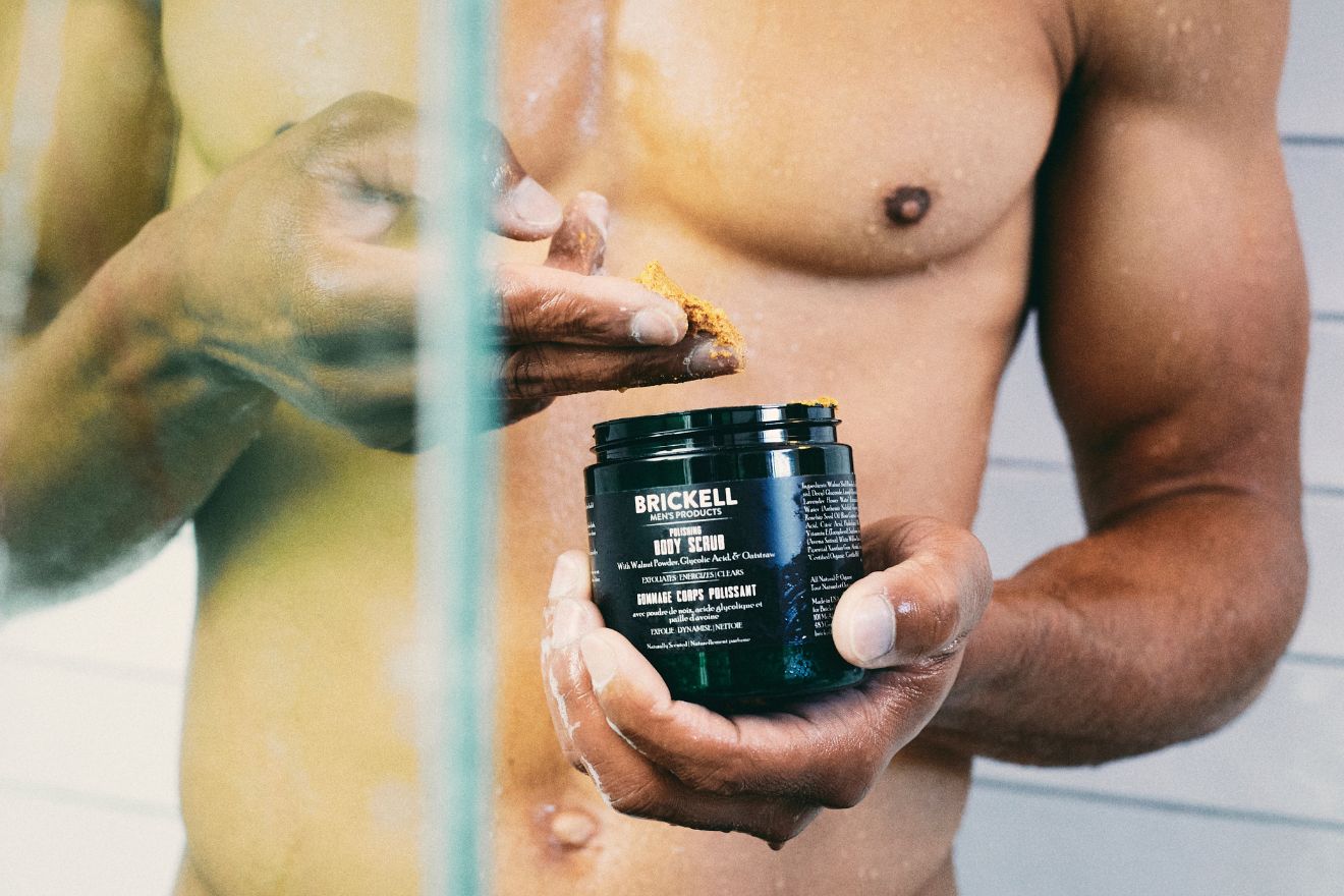 Man scooping polishing body scrub