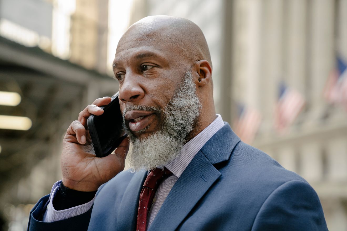 Man with beard talking on the phone