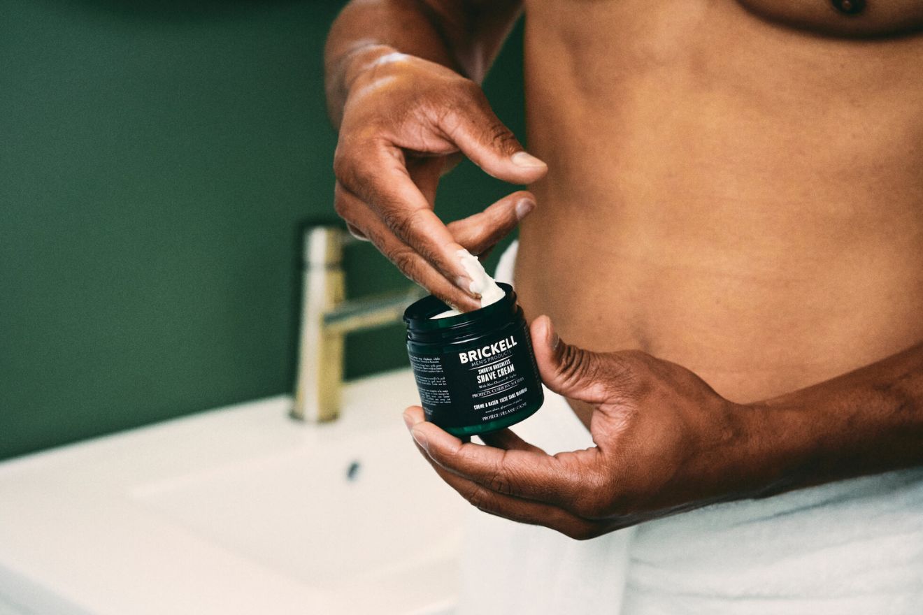 Man scooping shave butter from jar