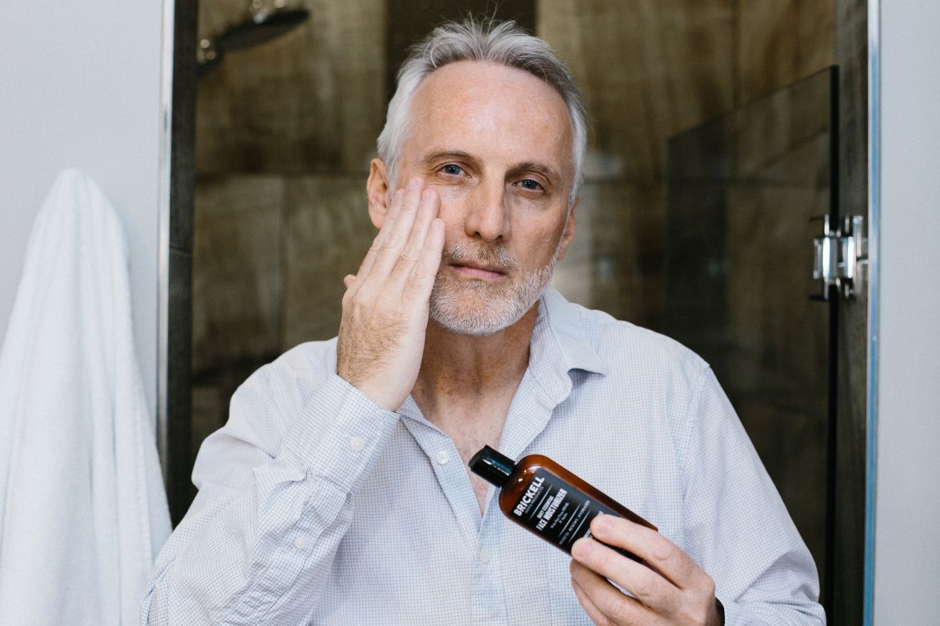 Man applying face lotion