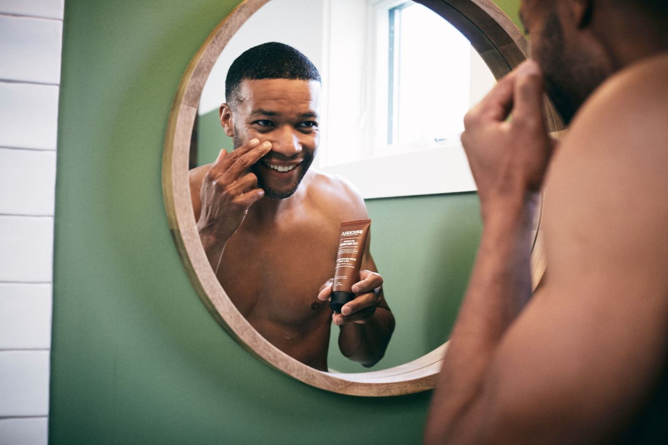 Man applying face moisturizer