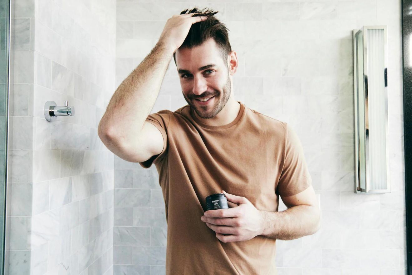 Man applying pomade to hair