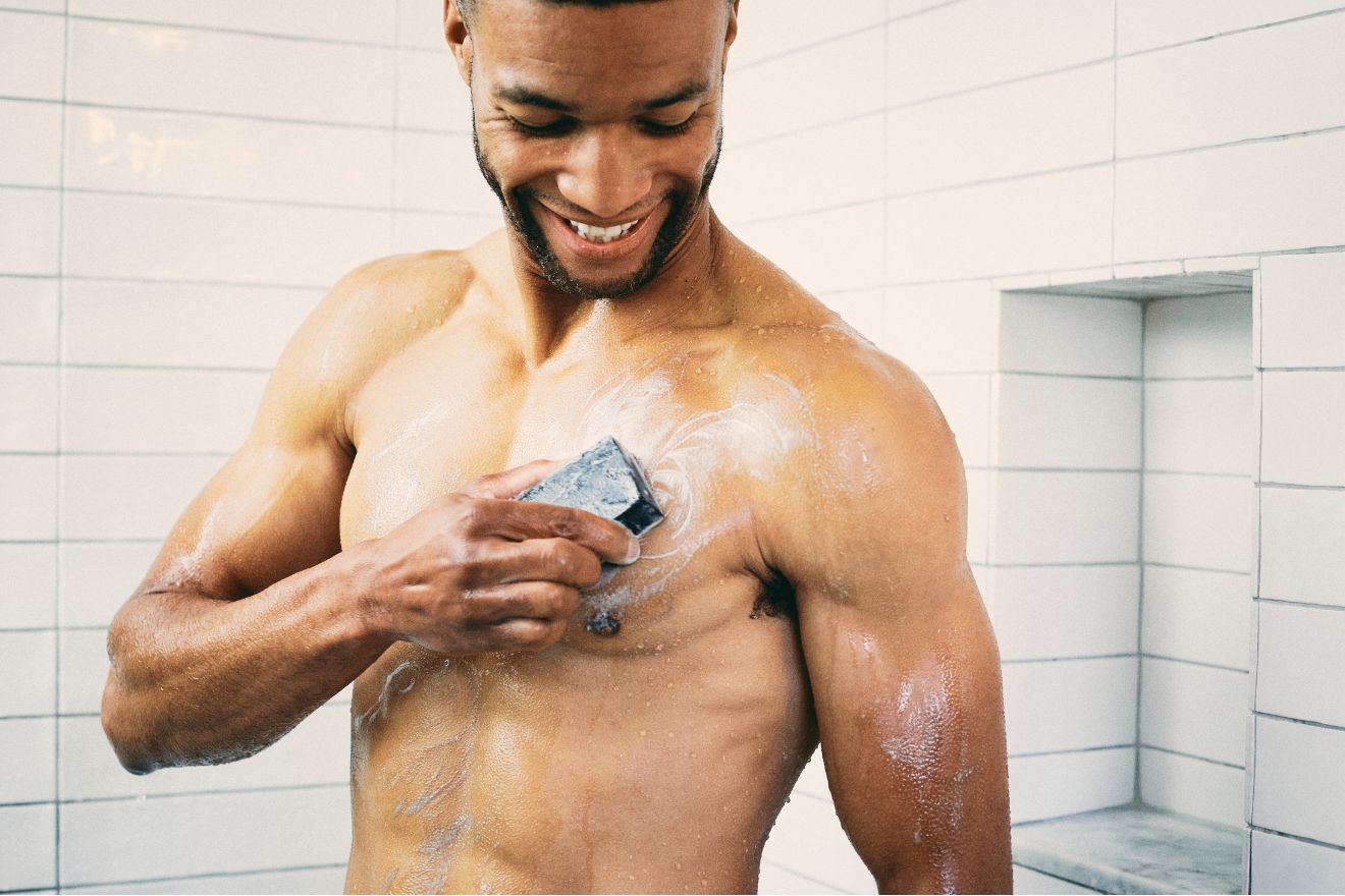 Man using bar soap in shower