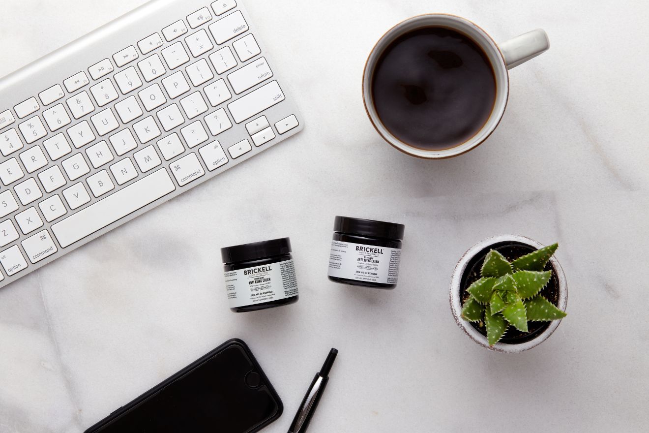 Skincare products on marble office desk