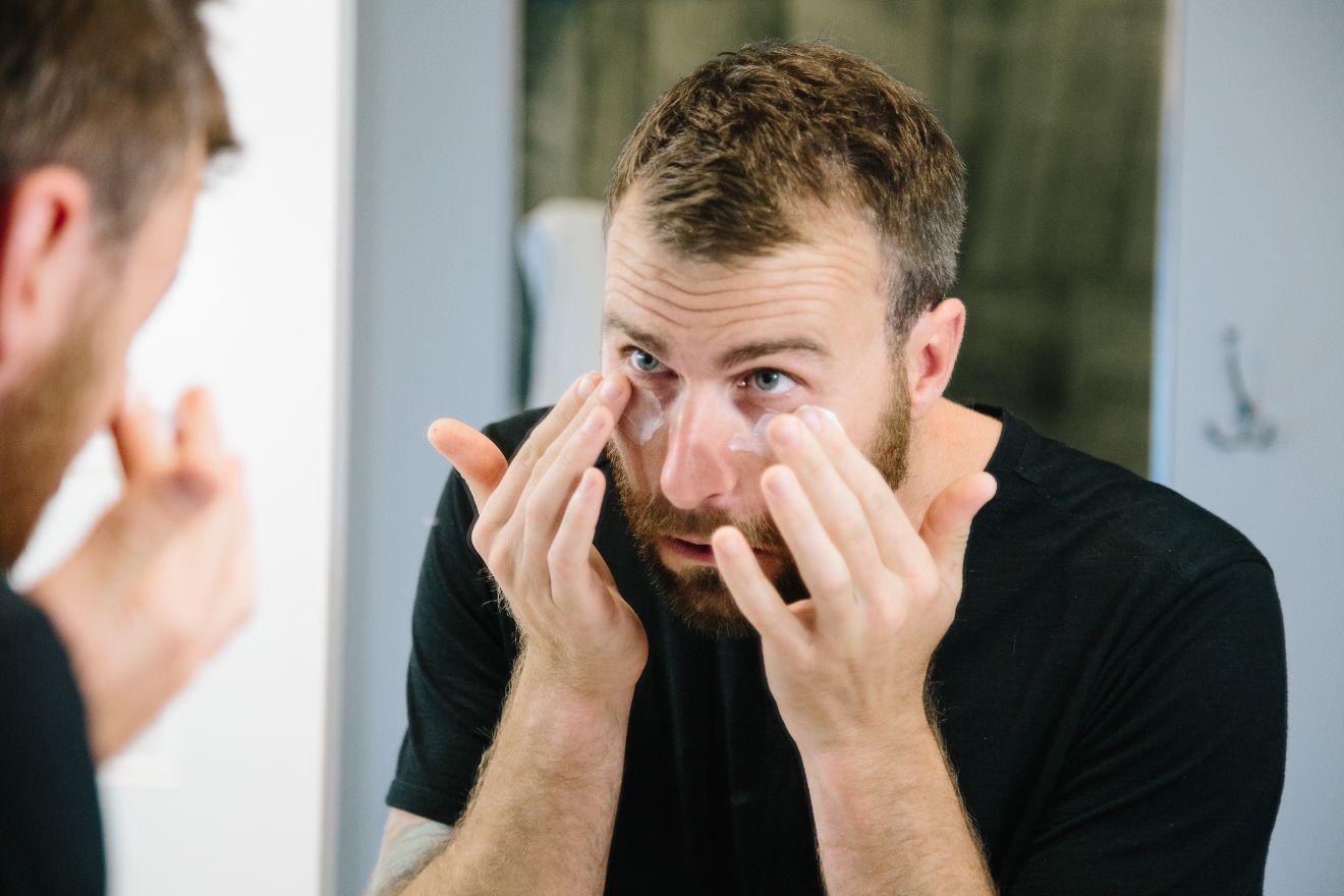 Man applying eye cream