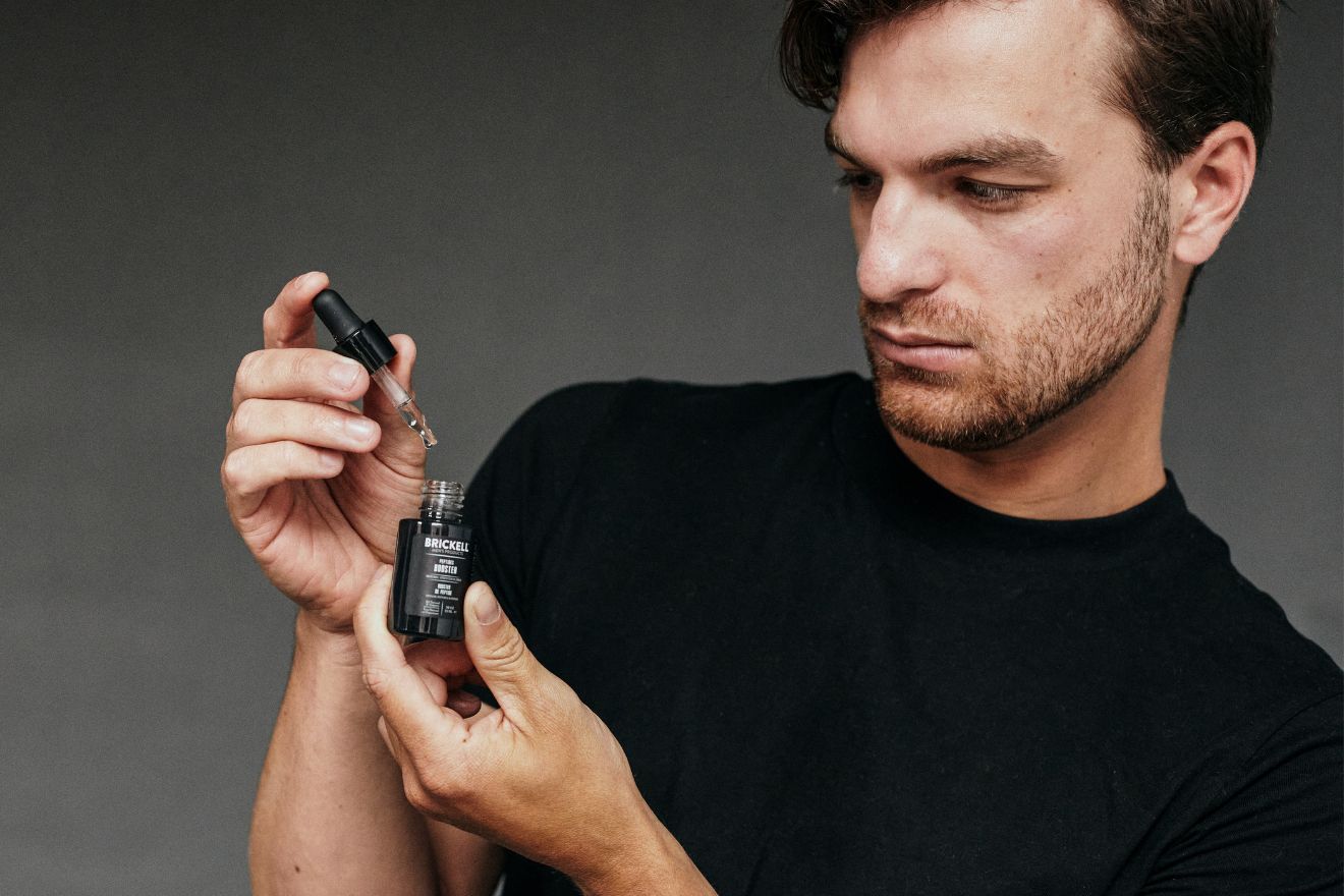 Man looking at skincare product