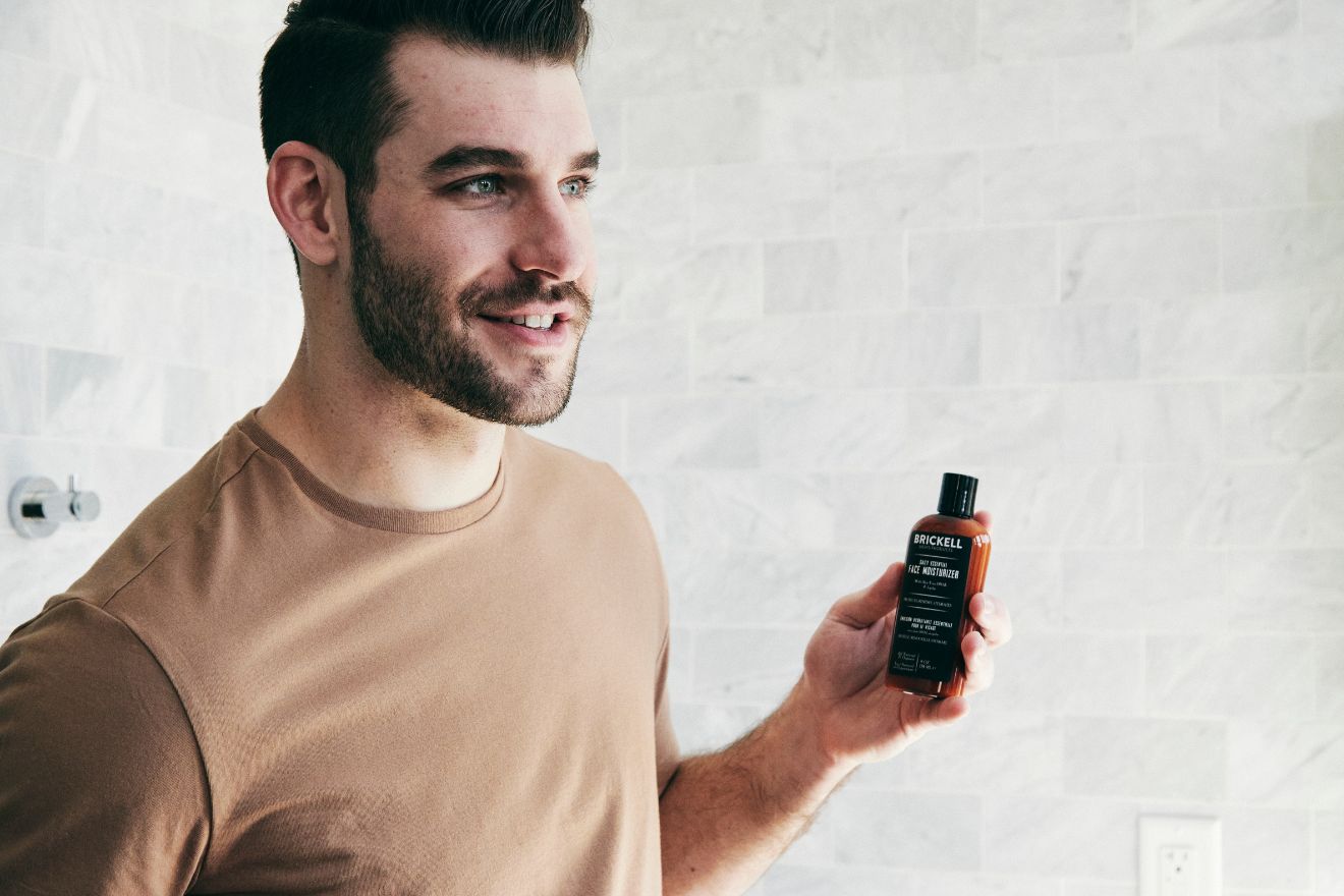 Man holding face moisturizer